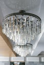 A two silver shining crystal chandelier on the ceiling one against another Royalty Free Stock Photo