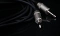 Two silver TRS connectors for the analog audio signal are placed against a black background. Professional jack connectors for Royalty Free Stock Photo