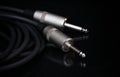 Two silver TRS connectors for the analog audio signal are placed against a black background. Professional jack connectors for Royalty Free Stock Photo