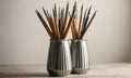 Two silver vases with ribbed patterns hold collection pencils in various colors, arranged in visually Royalty Free Stock Photo