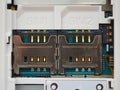 Two SIM card slots in old white mobile phone close up Royalty Free Stock Photo