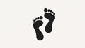 Two simple black footprints, slightly offset, against a light gr Royalty Free Stock Photo