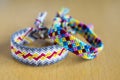 Two simple handmade homemade natural woven bracelets of friendship on wooden table Royalty Free Stock Photo