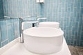 Two sinks in the bathroom sink next to stylish decorations. A beautiful sink with a metal faucet next to an mirror and a Royalty Free Stock Photo