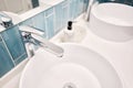 Two sinks in the bathroom sink next to stylish decorations. A beautiful sink with a metal faucet next to an mirror and a Royalty Free Stock Photo