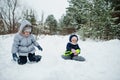 Two sister baby girls in winter nature. Outdoors in snow