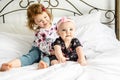 The Two sister baby in white bed at home