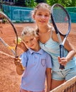 Two sister girl athlete with racket and ball