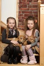 Two sister girls with puppies Royalty Free Stock Photo