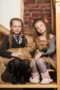 Two sister girls with puppies Royalty Free Stock Photo