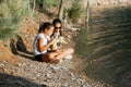 Two sisters drinking a refreshment by the lake