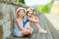 Two sisters exploring the famous Orvieto, a medieval hill town, rising above the almost-vertical faces of tuff cliffs and Royalty Free Stock Photo