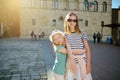 Two sisters exploring old narrow streets of Montepulciano town, located on top of a limestone ridge surrounded by vineyards. Royalty Free Stock Photo