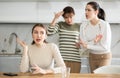 Two sisters during family quarrel accuse woman Royalty Free Stock Photo