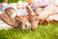 Two sisters feet lying on grass at park