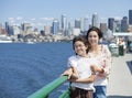 Two sisters on ferry deck, Seattle skyline