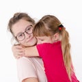 Two sisters hugging, Studio portrait on white background Royalty Free Stock Photo