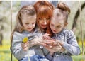 Two sisters kiss their mother on a walk Royalty Free Stock Photo