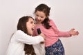 Two sisters with a microphone fooling around and singing Royalty Free Stock Photo