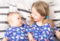 Two sisters. Older sister kid hugging his newborn little sister. Royalty Free Stock Photo