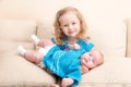 Two sisters. Older sister kid hugging his newborn little sister. Royalty Free Stock Photo