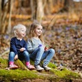 Two sisters picking the first flowers of spring Royalty Free Stock Photo