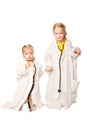 Two sisters playing as doctors. Royalty Free Stock Photo