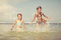 Two sisters playing on the beach Royalty Free Stock Photo