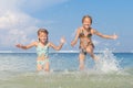 Two sisters playing on the beach Royalty Free Stock Photo