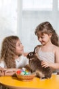 two sisters playing with Easter Bunny