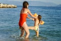 Two sisters playing games and swimming in the sea