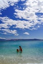 Two sisters playing games and swimming in the sea