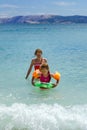 Two sisters playing games and swimming in the sea