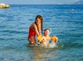 Two sisters playing games and swimming in the sea