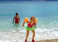 Two sisters playing games and swimming in the sea