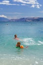 Two sisters playing games and swimming in the sea