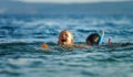 Two sisters playing games and swimming in the sea