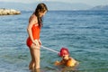 Two sisters playing games and swimming in the sea