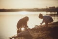 Two sisters playing on the shore of the lake