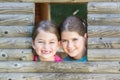 Two sisters playing in tree house Royalty Free Stock Photo