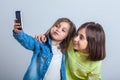 Two sisters posing and taking selfies in the studio Royalty Free Stock Photo