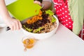 Two sisters preparing granola together