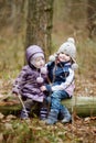 Two sisters sitting on a log Royalty Free Stock Photo