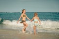 Two sisters splashing on the beach