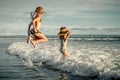 Two sisters splashing on the beach