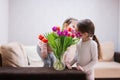 Two sisters with spring tulip bouquet. Holiday decor with flowers colorful tulips Royalty Free Stock Photo