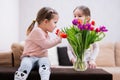 Two sisters with spring tulip bouquet. Holiday decor with flowers colorful tulips Royalty Free Stock Photo