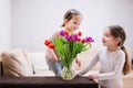 Two sisters with spring tulip bouquet. Holiday decor with flowers colorful tulips Royalty Free Stock Photo