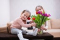 Two sisters with spring tulip bouquet. Holiday decor with flowers colorful tulips Royalty Free Stock Photo