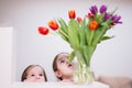 Two sisters with spring tulip bouquet. Holiday decor with flowers colorful tulips Royalty Free Stock Photo